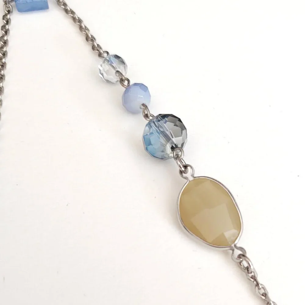 Long silver necklace with blue and yellow glass beads